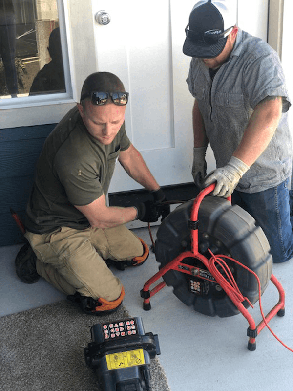 H2O Plumbing technicians performing camera-assisted drain cleaning at an exterior cleanout in Vancouver WA
