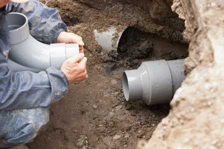 Drain and sewer pipe repair work in an open trench by H2O Plumbing technicians in Southwest Washington