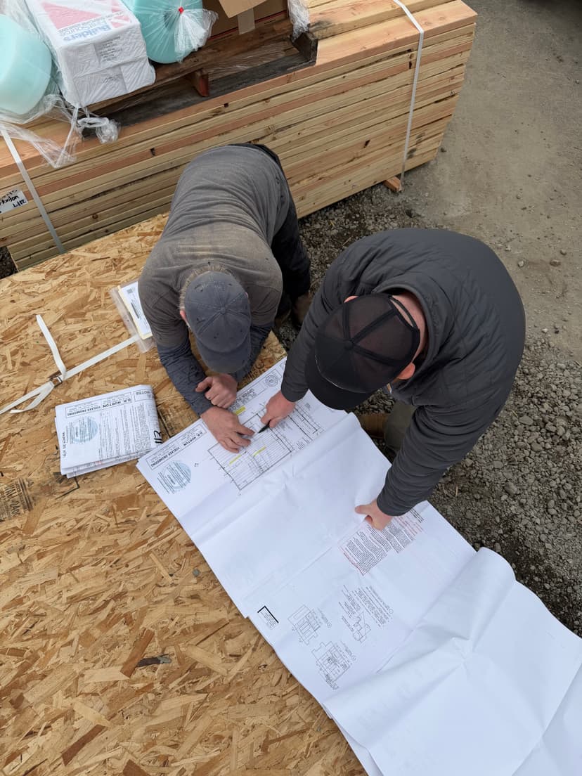 Our team reviewing plumbing blueprints on a new-construction site