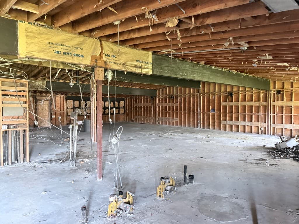 Large commercial floor opened for phased plumbing repipe planning and coordination
