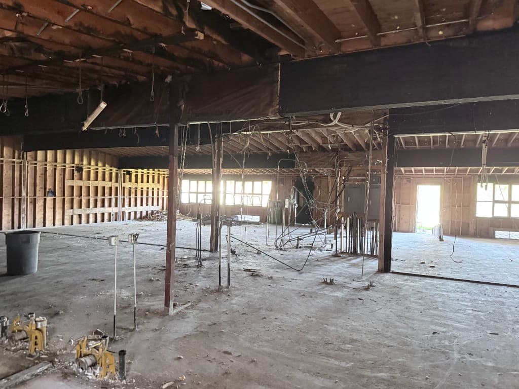 Large commercial floor opened for phased plumbing repipe planning and coordination