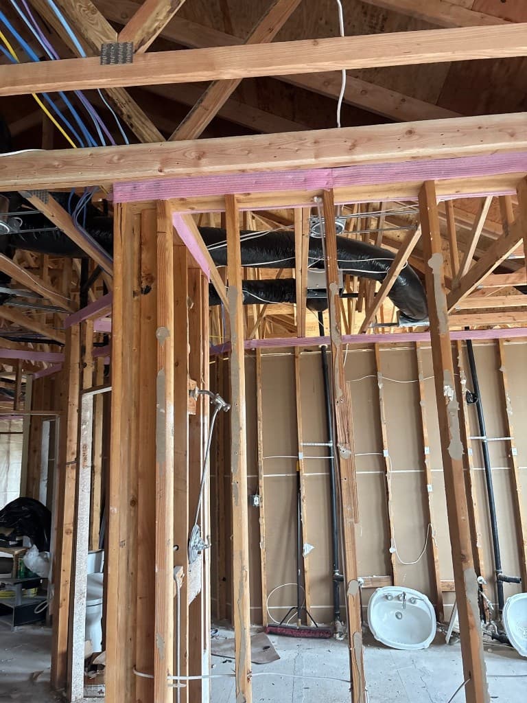 Framed wall area with vent and branch line routing during rebuild rough-in
