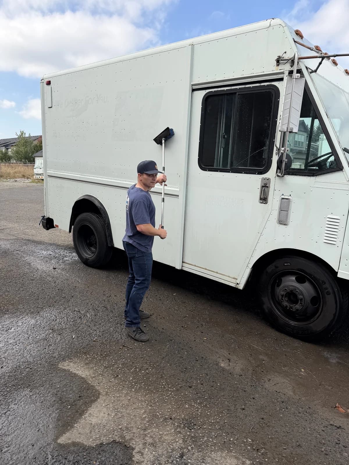 H2O crew member standing beside a white service truck
